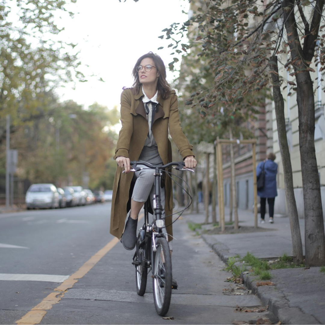 Square image of woman riding a bike